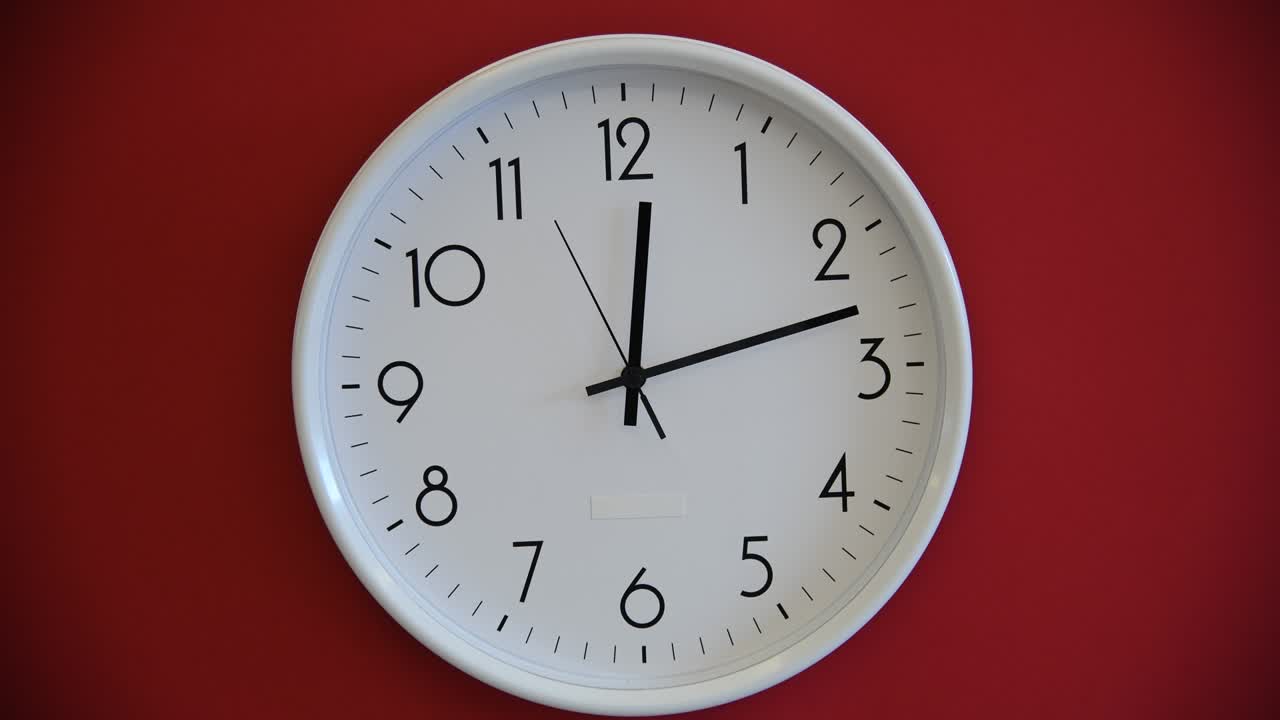 Orologio da parete bianco su sfondo rosso