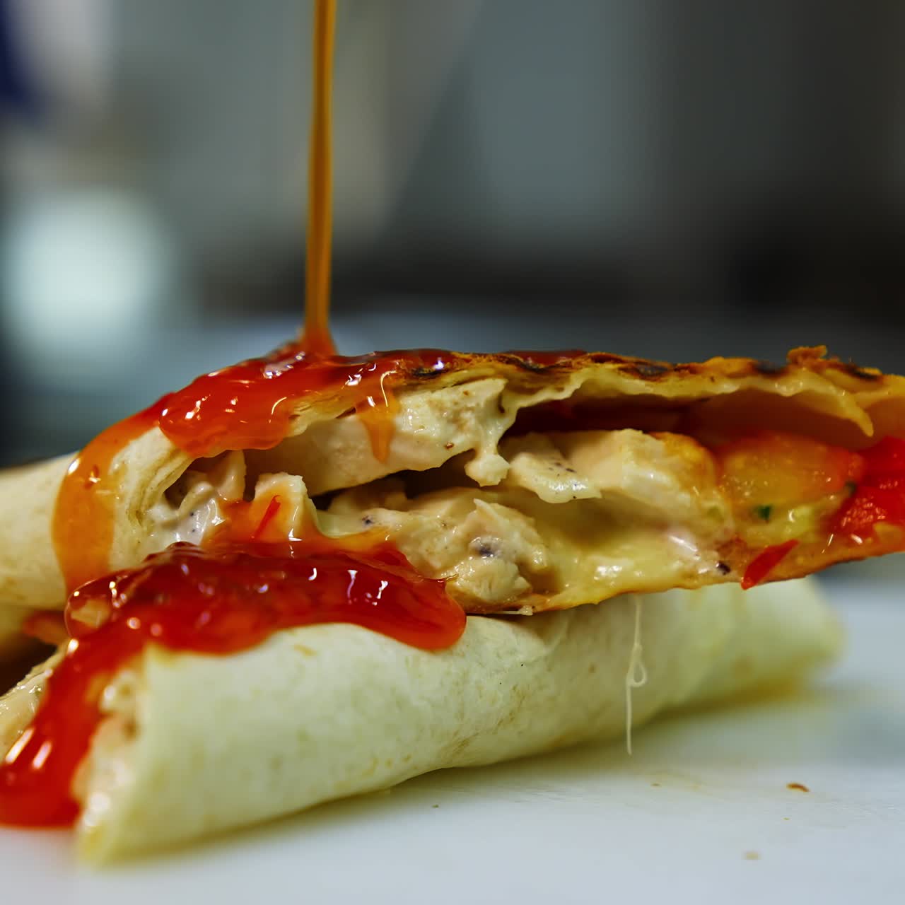 Tasty pita roll with vegetables and meat poured with red souce. Tasty fast food prepared in restaurant