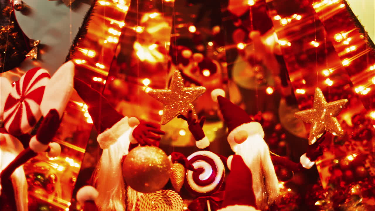 Multiple Santa Claus Christmas decorations moving in bubbles in the courtyard of the Monte Carlo Casino