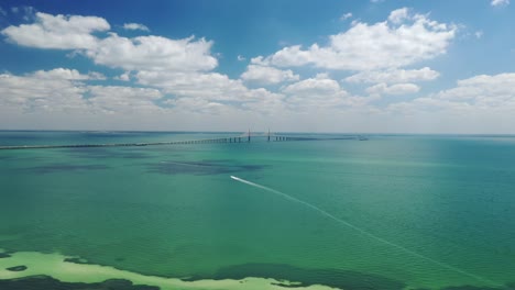 seascape with suspension bridge in the background, sunshine skyway bridge, tampa bay, florida, usa - aerial drone shot