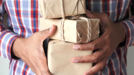 person holding stacked gift boxes