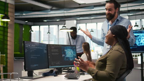 pleased startup office manager applauding female programmer for optimizing code