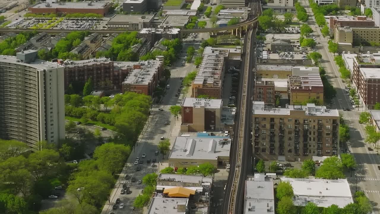 View of Chicago with buildings and elevated train line in daylight