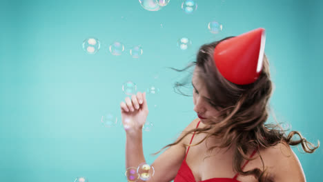 Crazy-face-woman-dancing-in-bubble-shower-slow-motion-photo-booth-blue-background