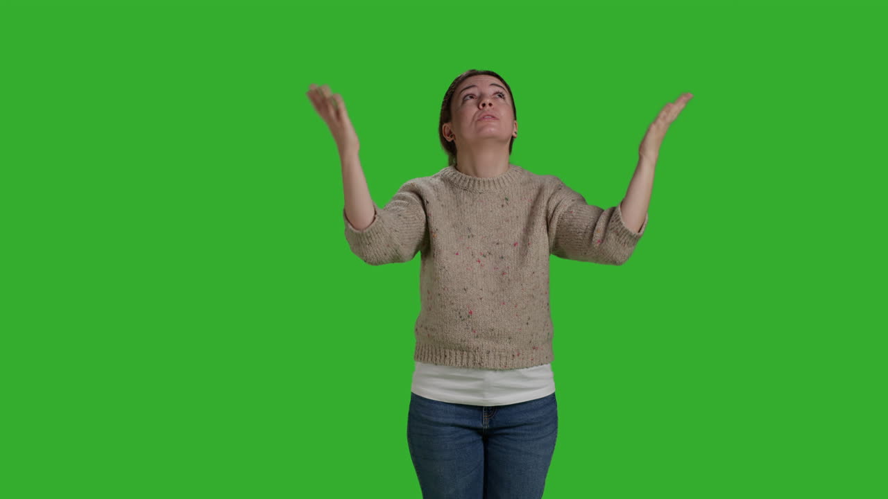 Woman praying on green screen