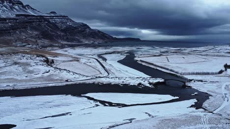 river and mountain against stormy sky in evening