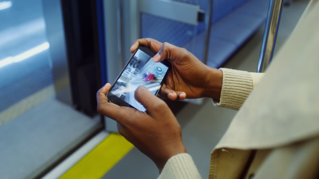 Person Playing Game on Phone on Train