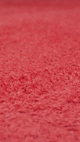 soft surface of crimson cow leather material as background extreme closeup. sewing clothes and accessories in workshop. fashion and modern design