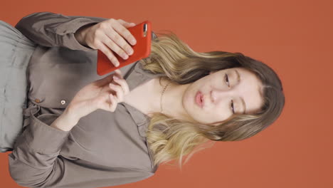 vertical video of the young woman who likes the new app. phone app.