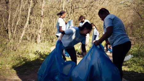 diverse group of activists gathering to clean up a forest area