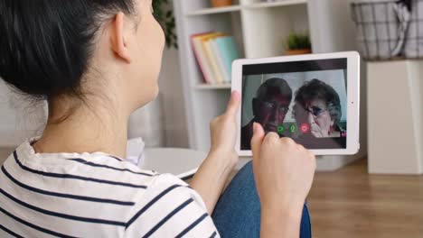 tracking video of man with face mask working at home