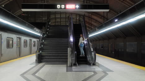 young lady subway with escalator in toronto