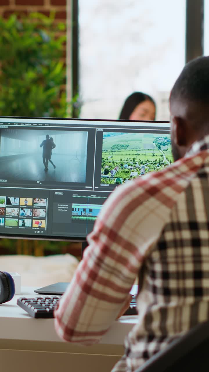 Vertical Video Male video editor works from modern home office in the living room