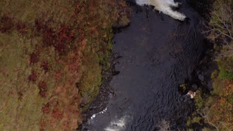 aerial drone top down flyover of lealt fall waterfall in skye scotland autumn