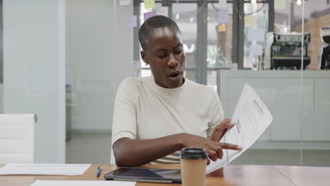 Portrait-of-african-american-businesswoman-with-shaved-head-making-video-call-in-office,-slow-motion