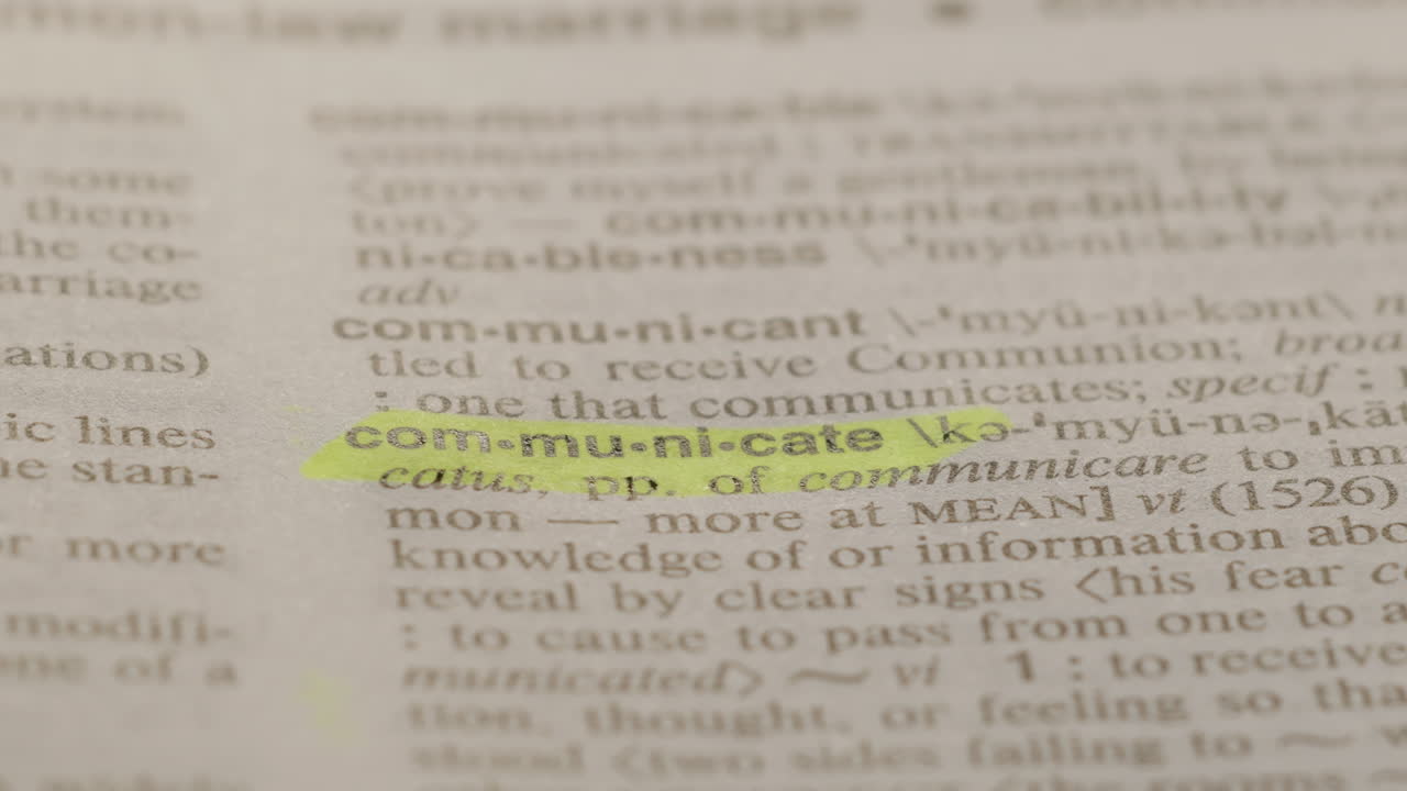 Communicate Business Dictionary Highlighter Concept, highlighting a word in a dictionary to show it's definition