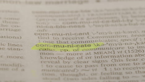 Communicate Business Dictionary Highlighter Concept, highlighting a word in a dictionary to show it's definition