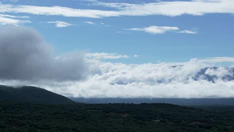 clouds drifting over lush green mountains and forests