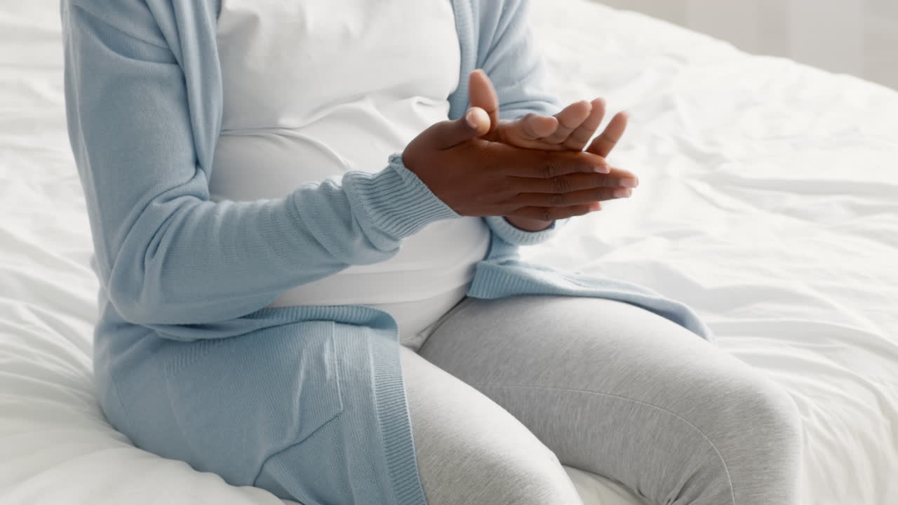Pregnant Woman Caring for Her Hands