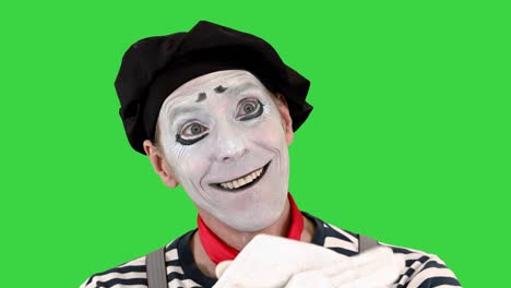 mime in white gloves performs something on a green screen, chroma key