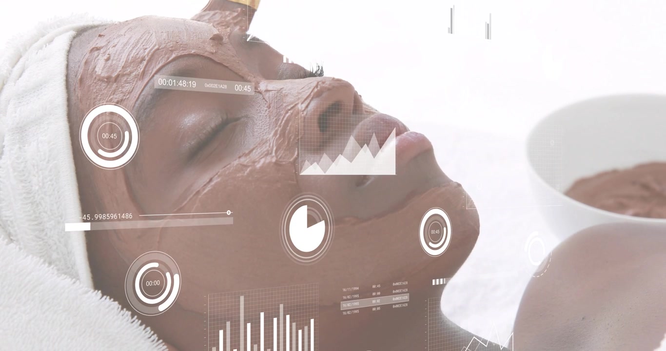 Woman reclined getting spa mask, brush entering frame spreading paste and HUD tracking for skincare