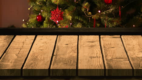 wooden foreground with christmas background of tree