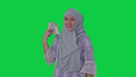 happy muslim woman money as fan green screen