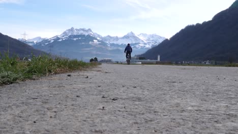 a cyclist riding on a road in the swiss alps in bilten, switzerland, ground-level