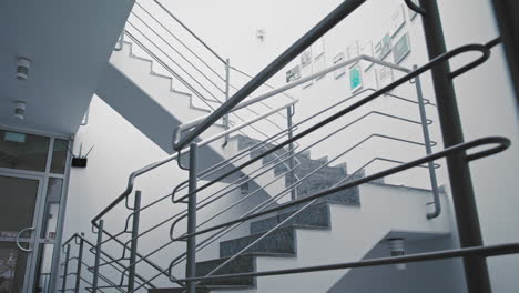 slow push in - slider shot of an empty office staircase.