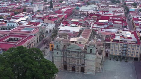 aerial view of oaxaca historic center, mexico, unesco world heritage city, roman catholic cathedral and neighborhood buildings, drone shot