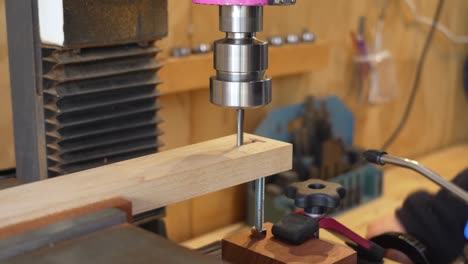 woodworker creating handmade items by milling into a small wooden beam