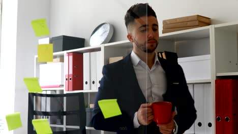 businessman in suit coat drinking from cup near glass wall