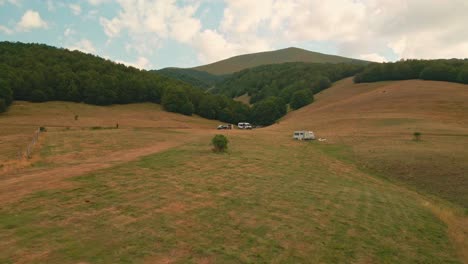 camper vans with tourist parked on the plains down the hills and valley in umbria, italy