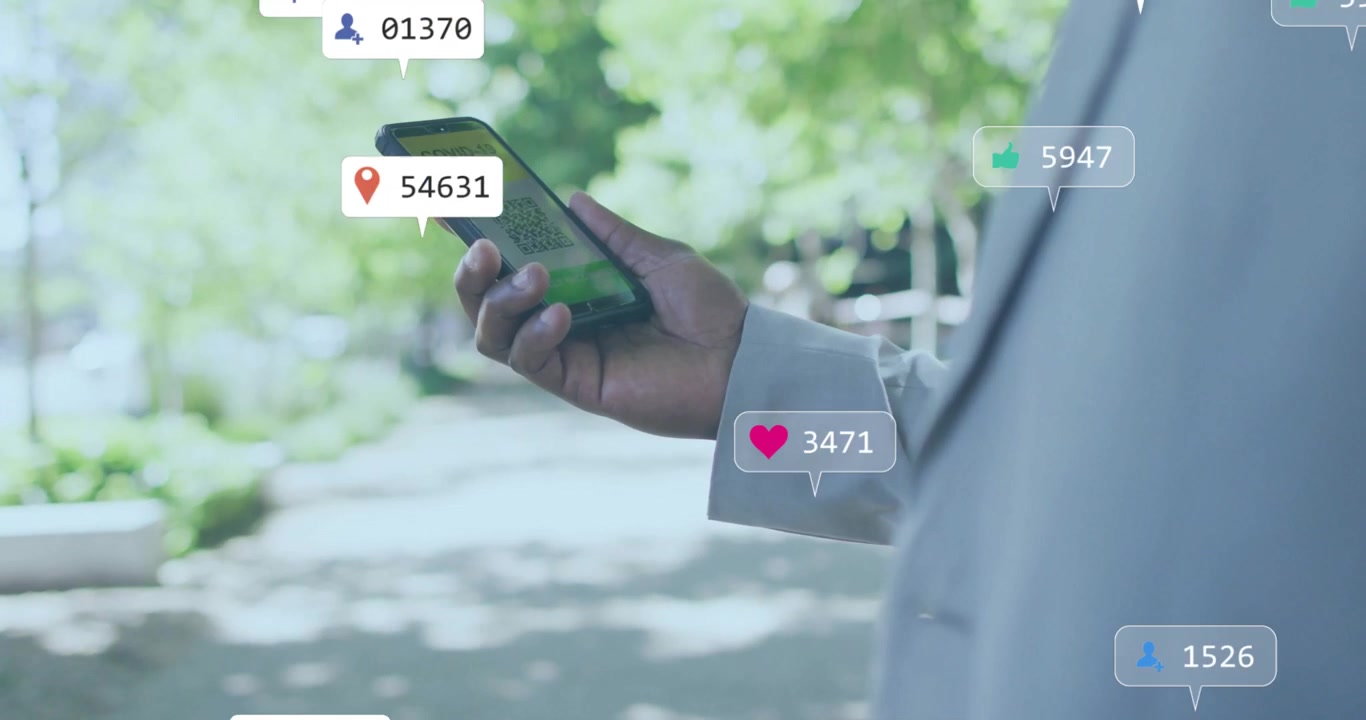 Man holding smartphone showing covid check QR code adding bell icon and stats growing around phone