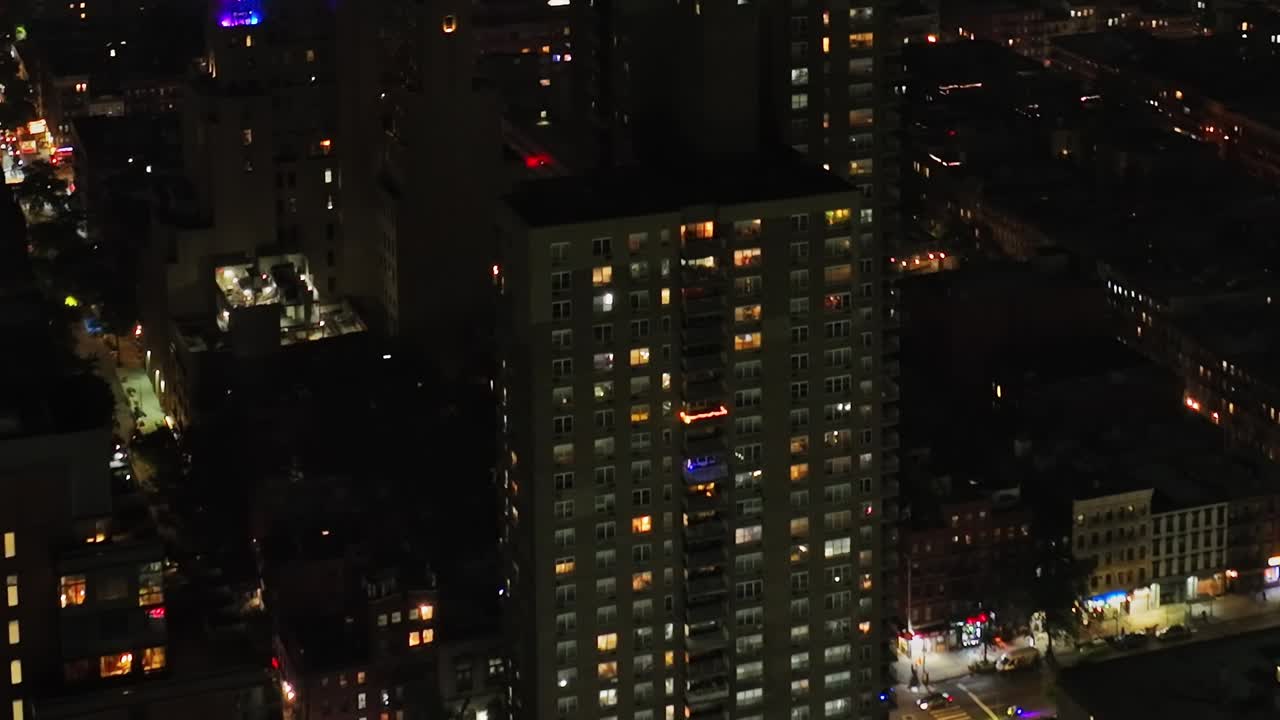 Nighttime aerial view of New York City revealing bright urban lights