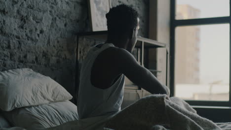 man waking up in bed