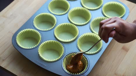 adding batter in baking pan for cupcake vegan pumpkin muffins using real roasted pumpkin in bowl healthy dairy-free recipe vegan