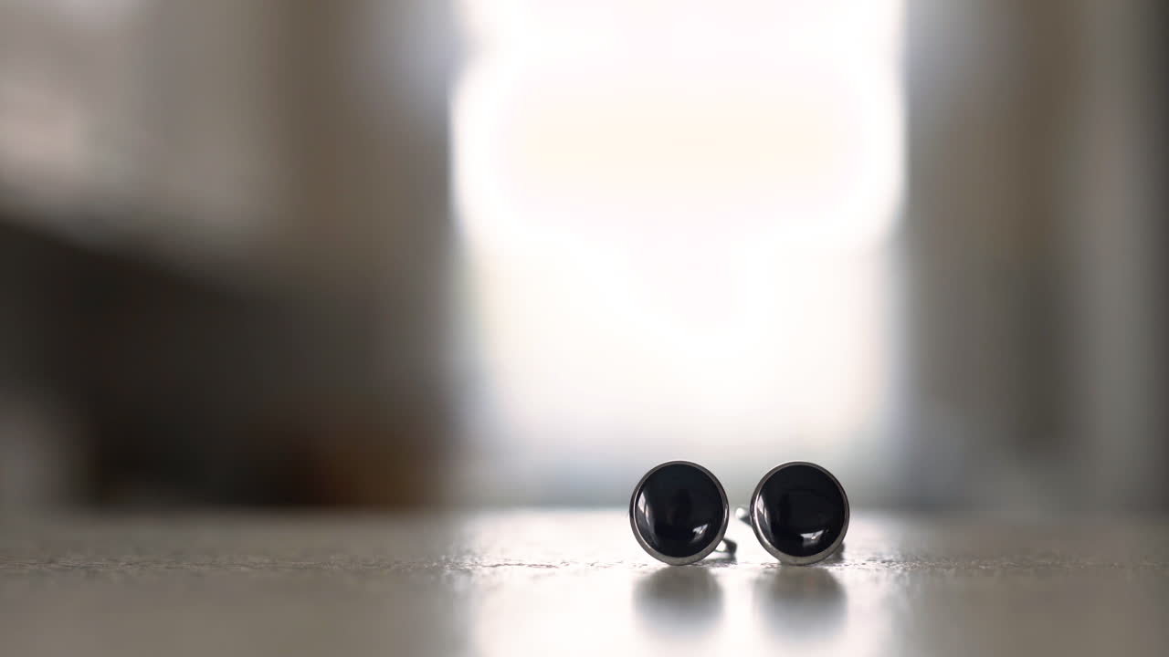 Closeup of Black Cufflinks on Table