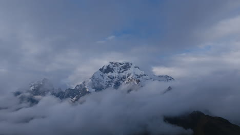 majestic snow-capped mountain peak rising above the clouds