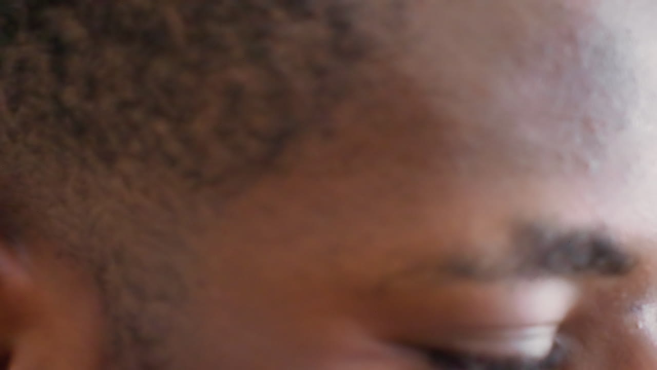 Black male profile closeup showing contemplative gaze. Subtle tear, textured skin, soft studio light and cinematic framing. Fiveframe sequence presents model as art student, actor, poet, musician