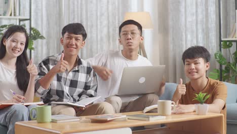 asian teen group studying at home, doing project, smiling and showing thumbs up gesture