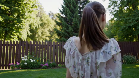 woman with ponytail in a sunny garden