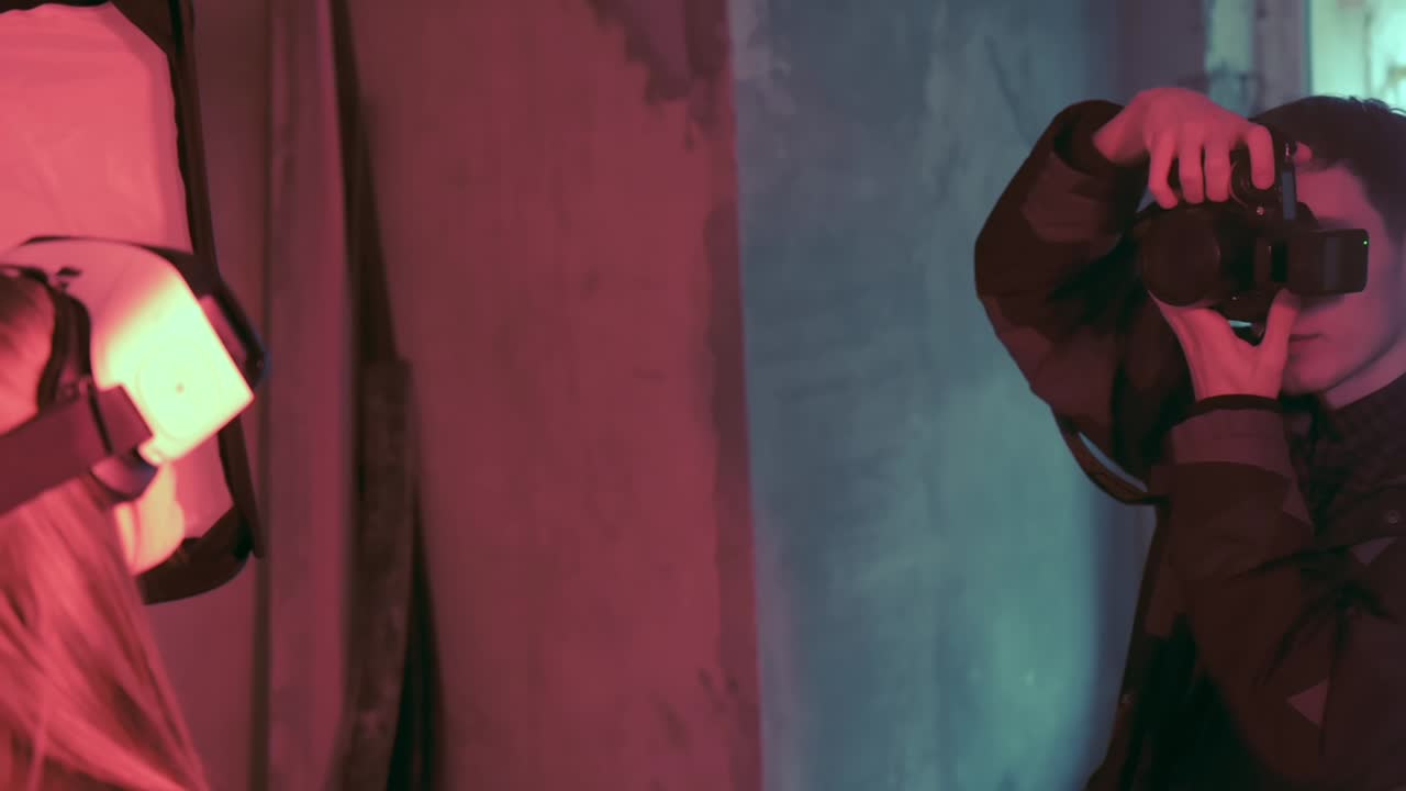 Photographer taking photo of a model with a virtual reality head set