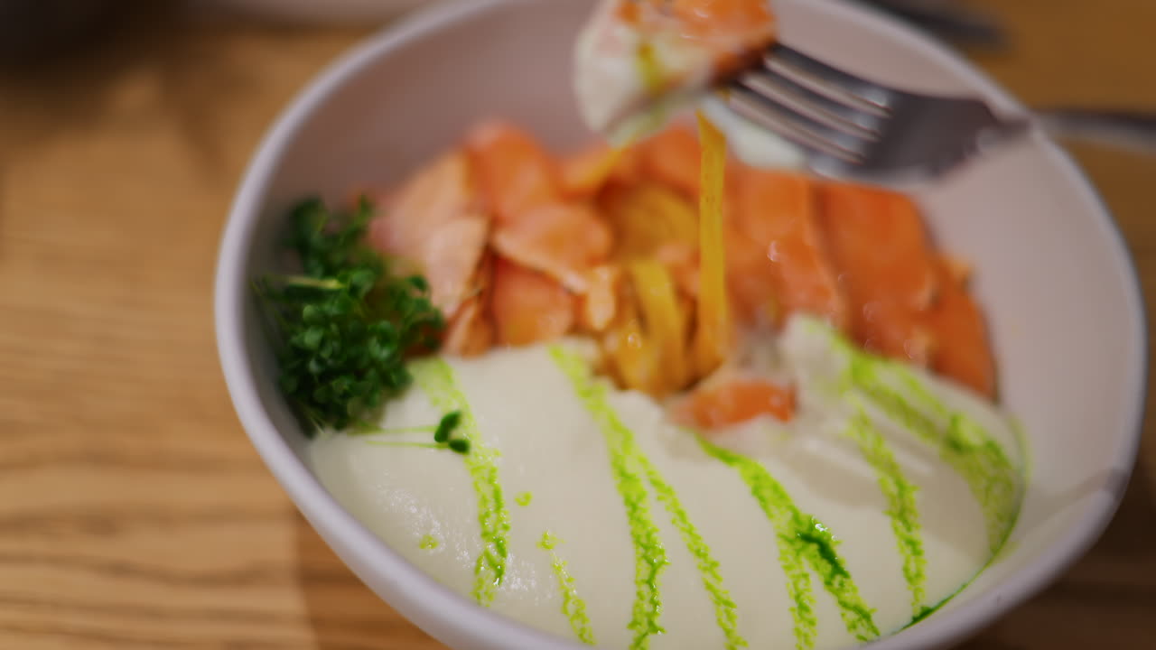 Close up of an avocado roll with sauce on a white plate at a restaurant