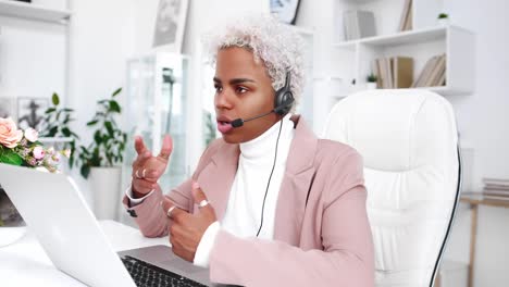 young african american woman having online interview via video call on laptop