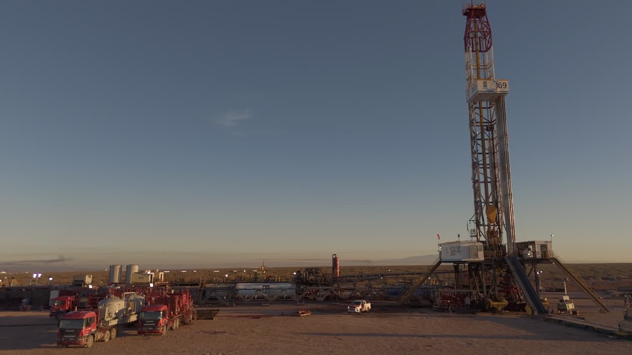 Oil rigs working in Argentina's Vaca Muerta field under blue sky