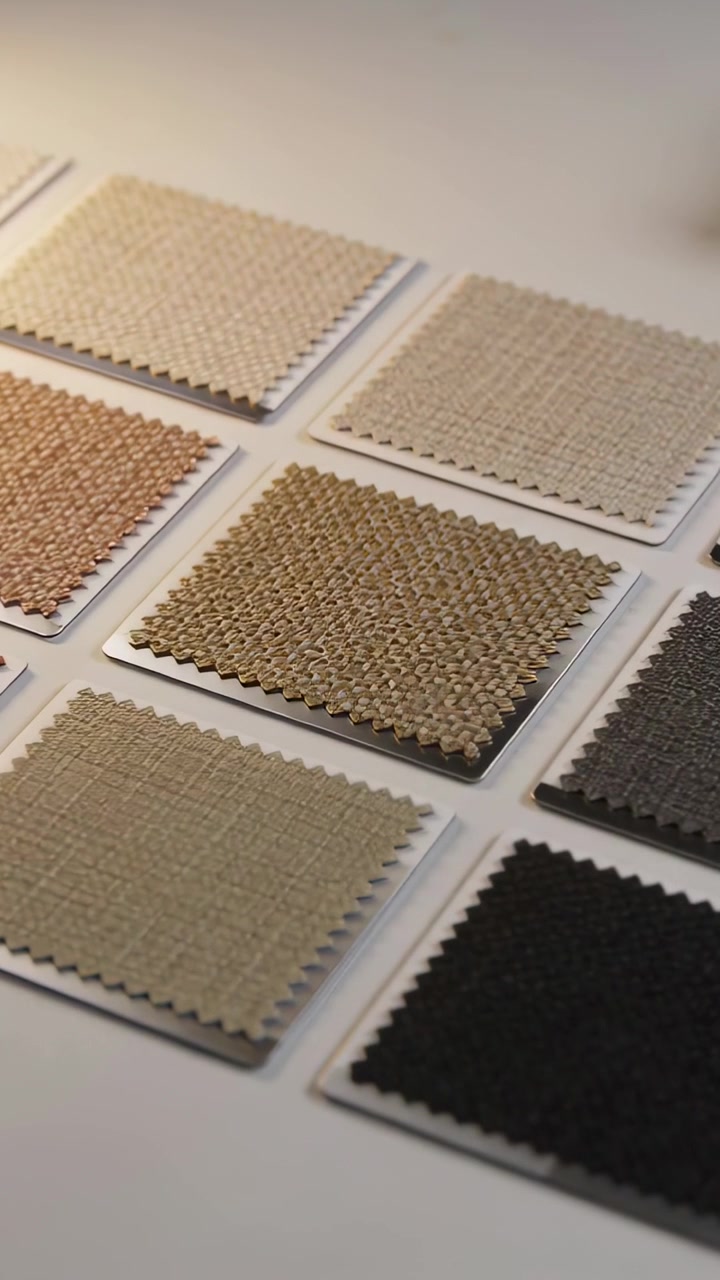 Vertical video: Panning camera over grid of square fabric swatches on white table, showing texture