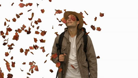 man standing under leaves falling on white screen