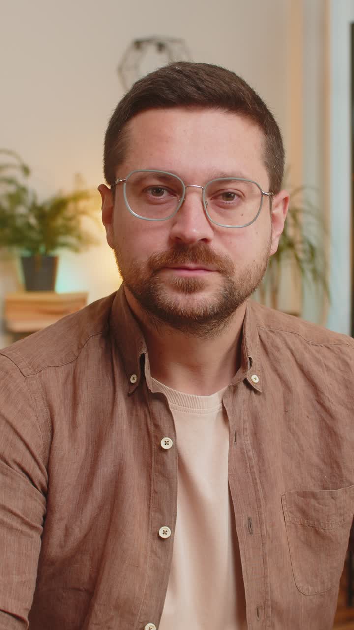 Caucasian young man guy looking at camera shocked by sudden victory sitting at home office table