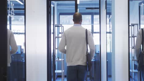 Businessman-walking-in-modern-office